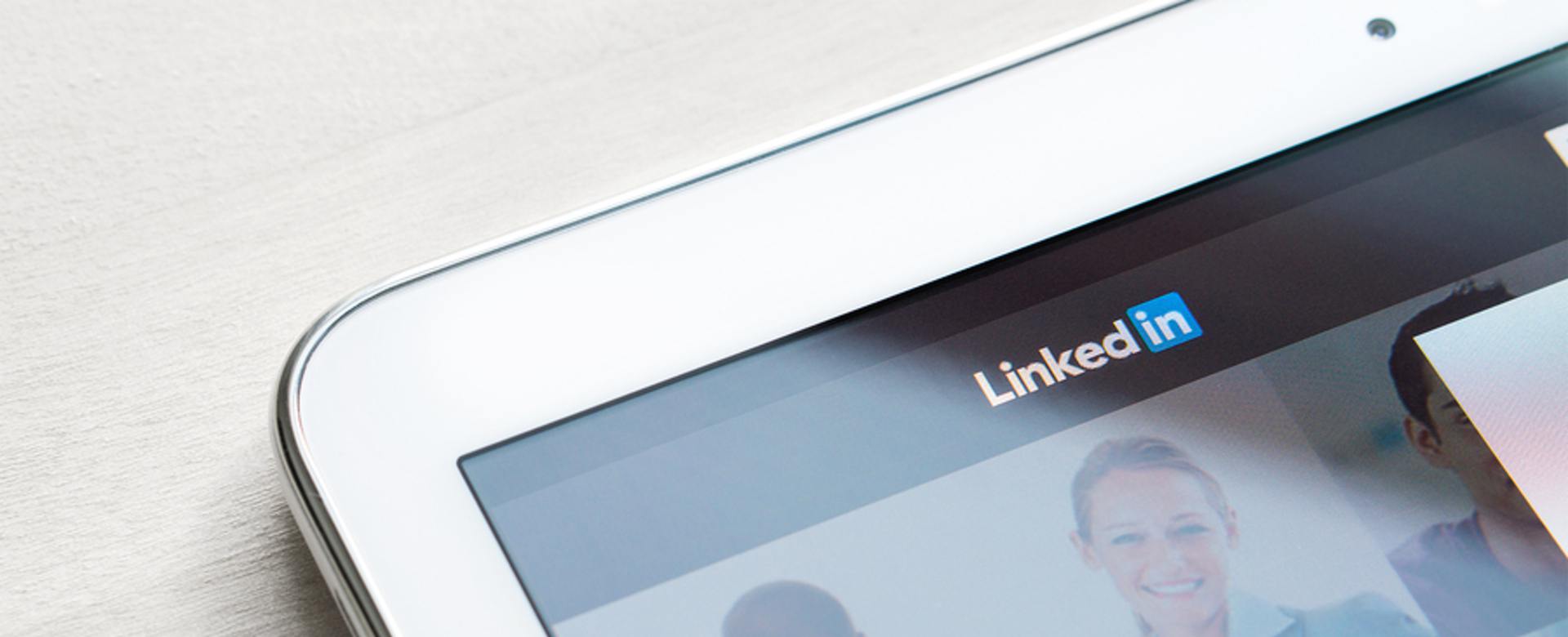 Tablet with LinkedIn page on screen.