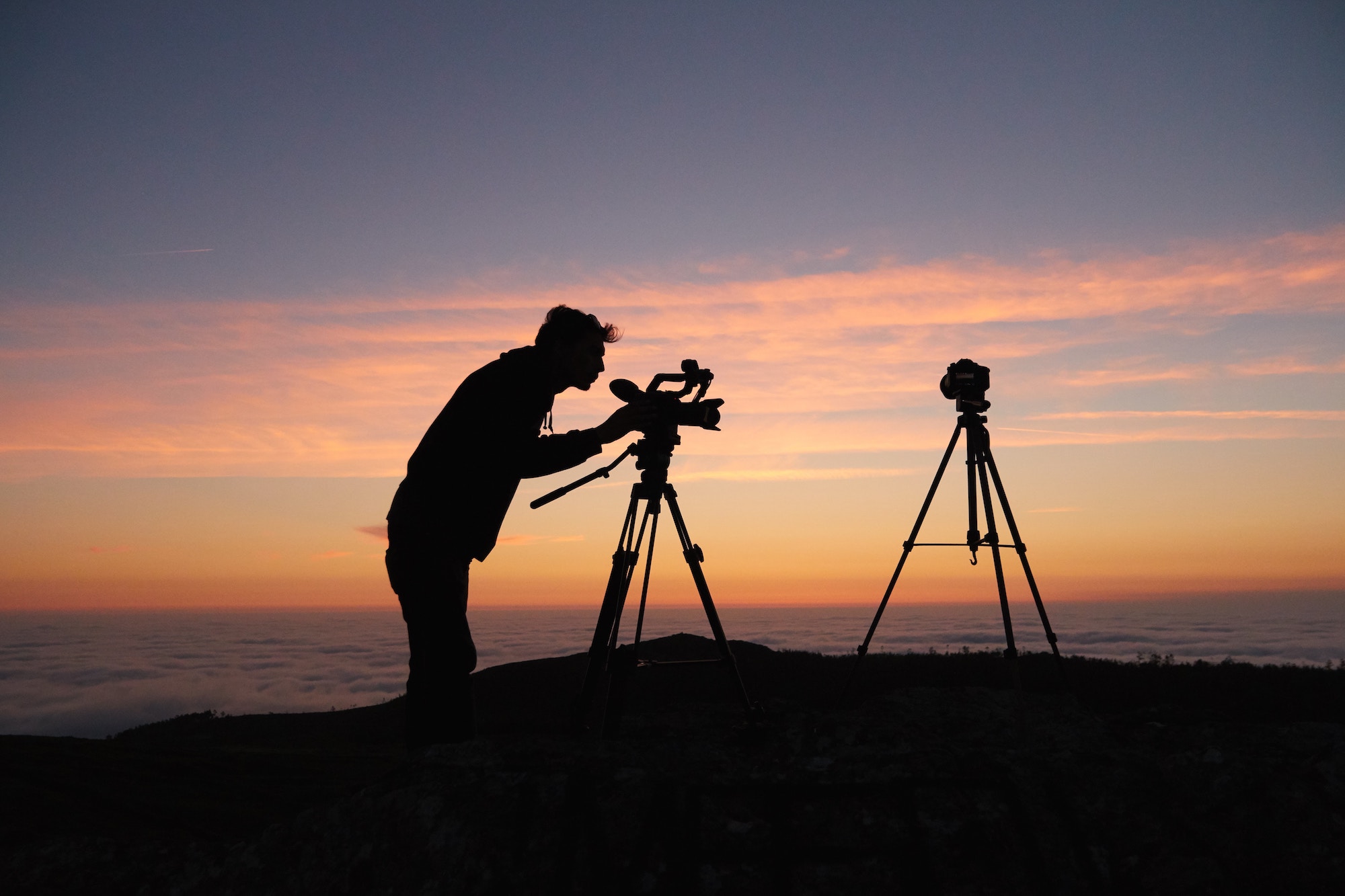 Camera operator shooting long form video at sunset. 